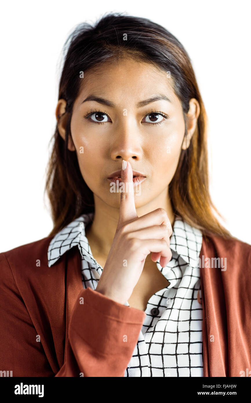 Serious businesswoman doing hush Stock Photo