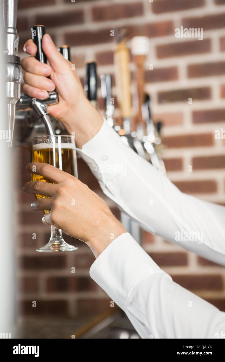 Masculine hands pouring beer Stock Photo