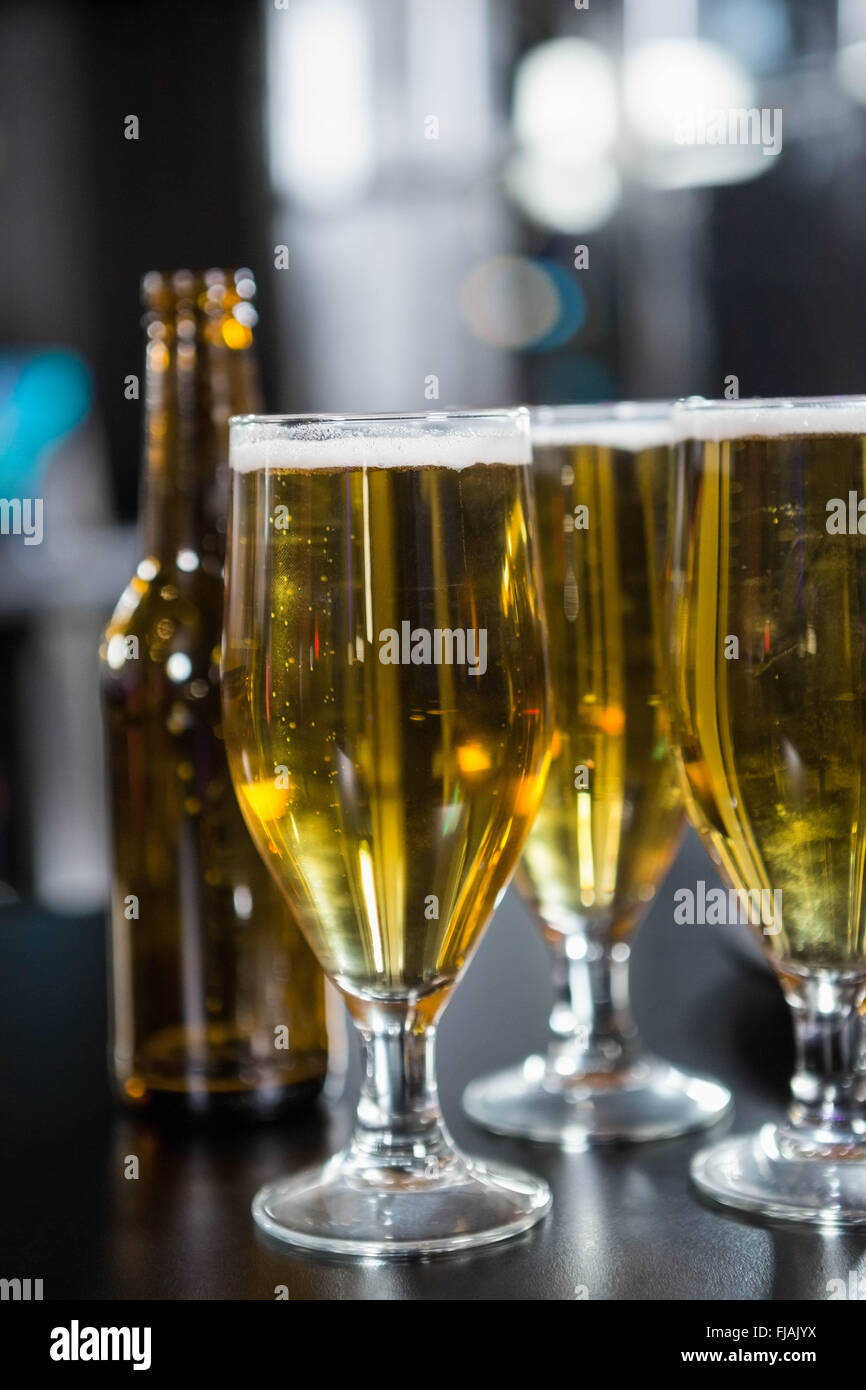 Glasses of beer ready to serve on bar counter Stock Photo Alamy