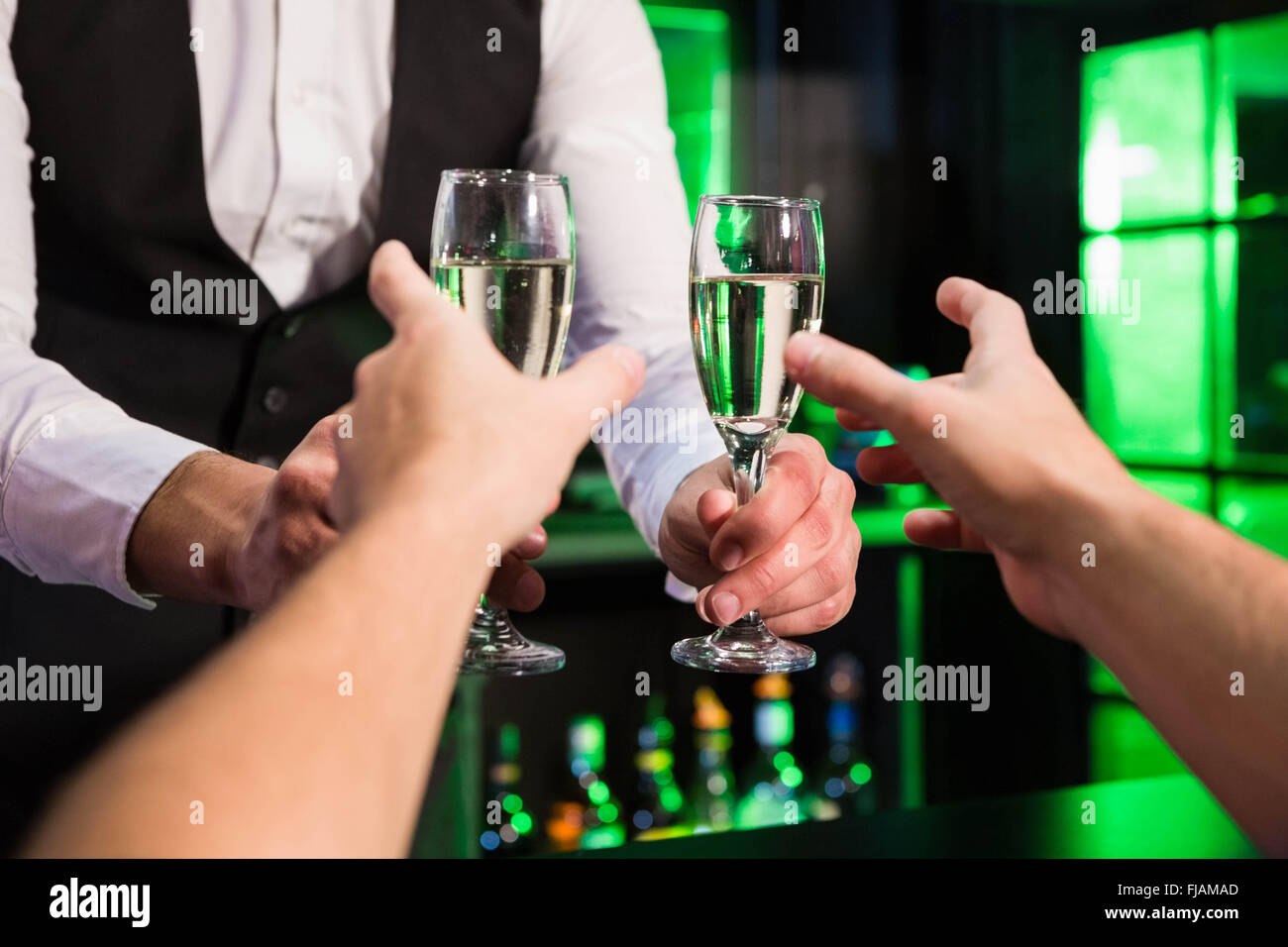 Bartender serving glass of champagne Stock Photo