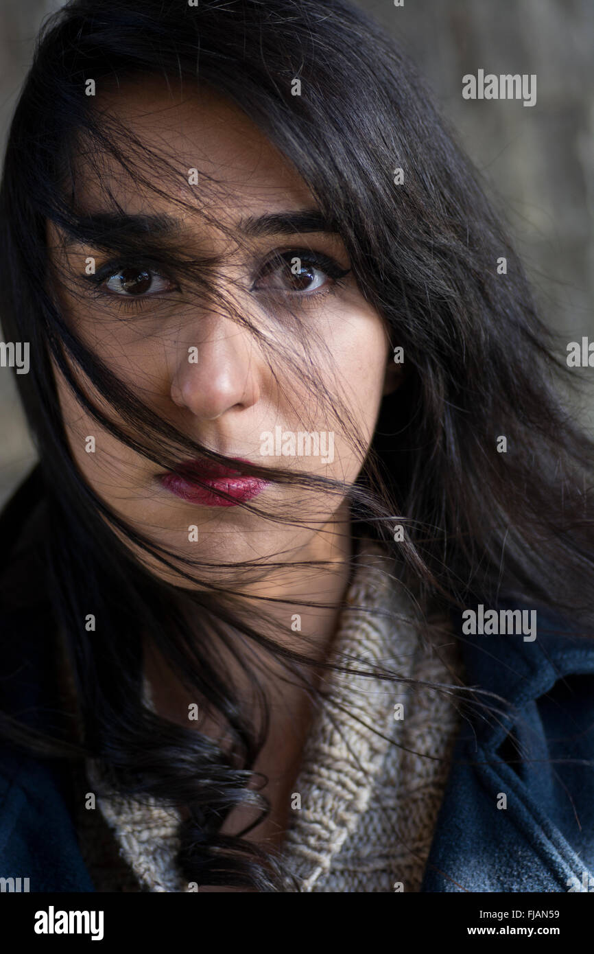 Serious young woman hair covering face Stock Photo