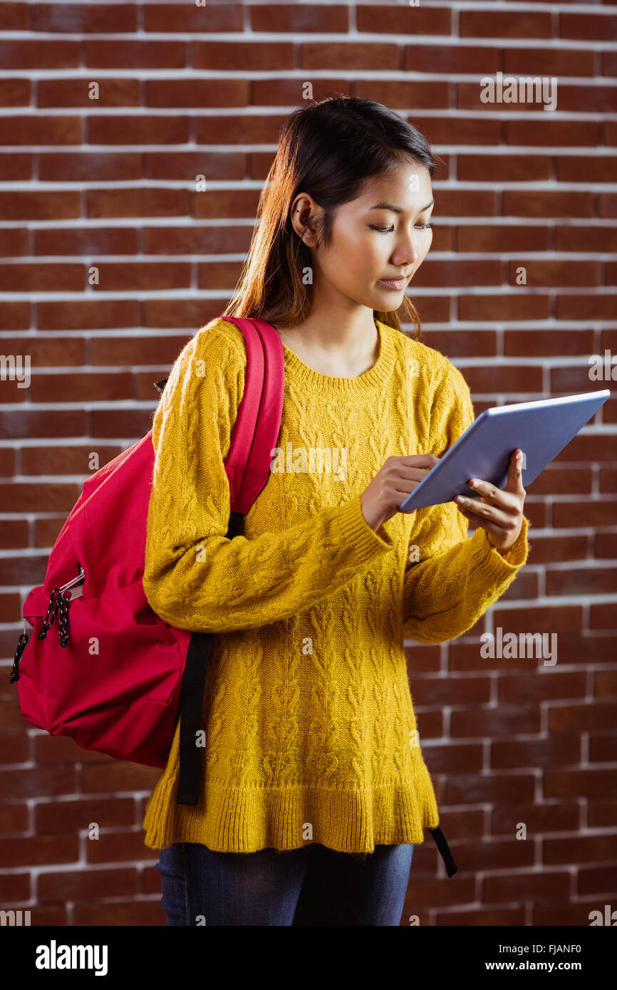 Focused asian female student using tablet Stock Photo