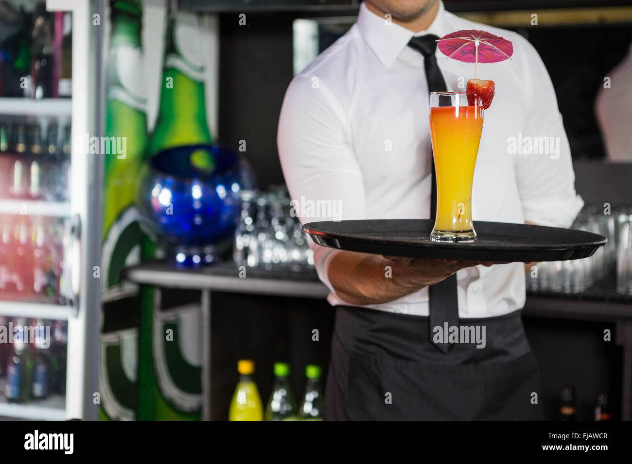 Mid section of bartender serving cocktail Stock Photo