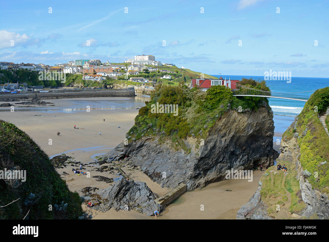 view across fistral beach to harbour with island house in newquay cornwall england with people on beach stock photo alamy