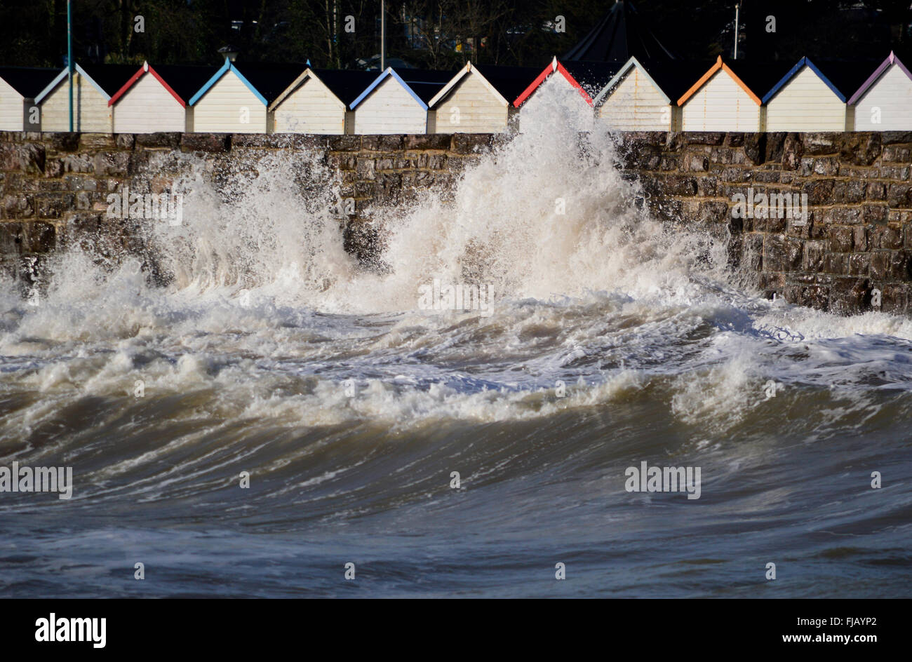 Rough sea against background of beach huts Stock Photo