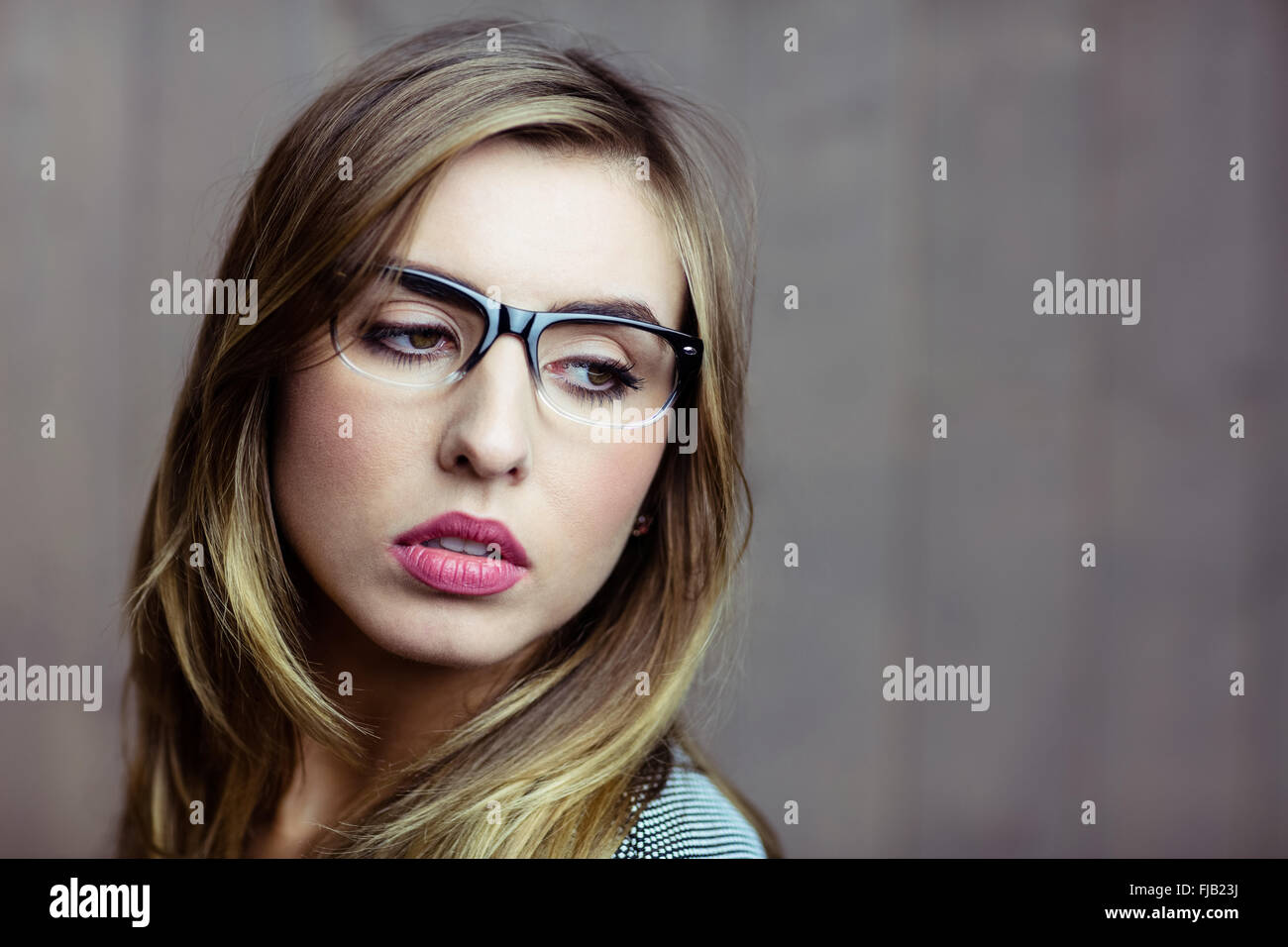 Pretty blonde woman day dreaming Stock Photo
