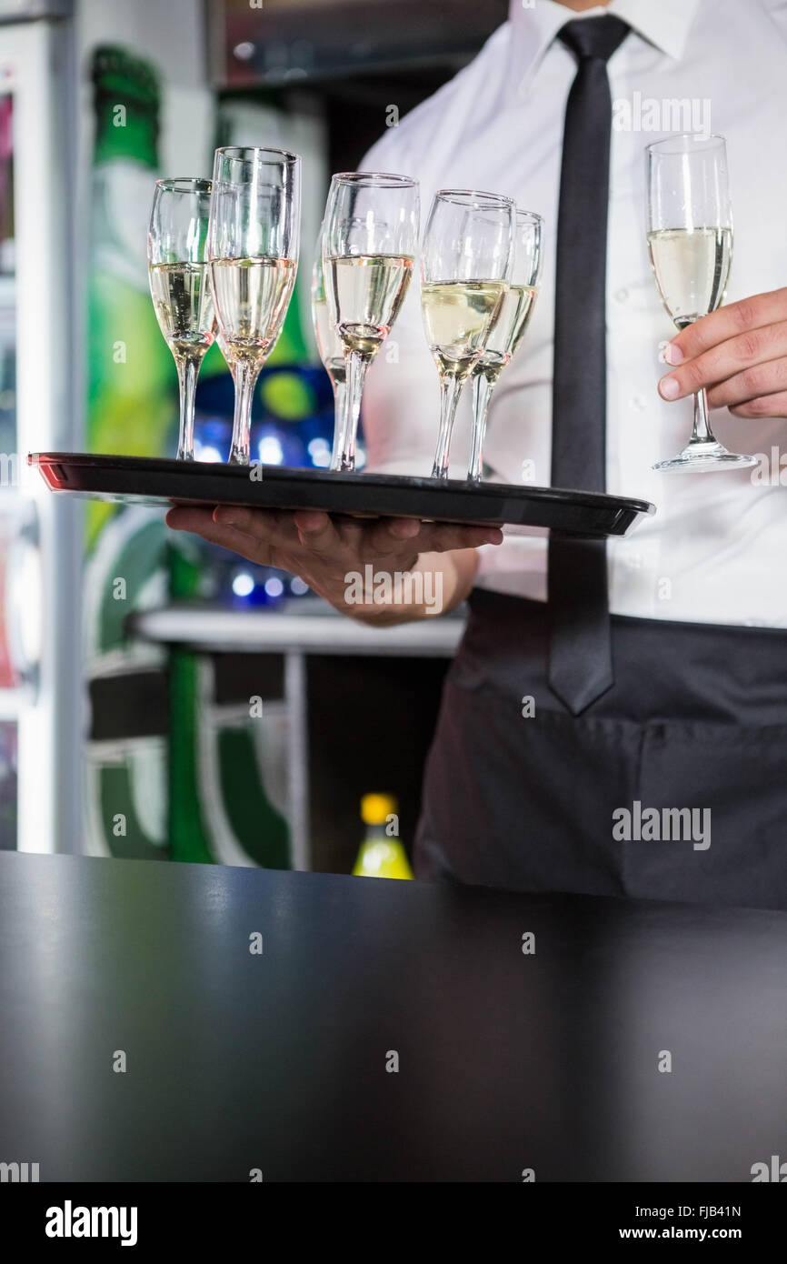 Mid section of bartender serving champagne Stock Photo