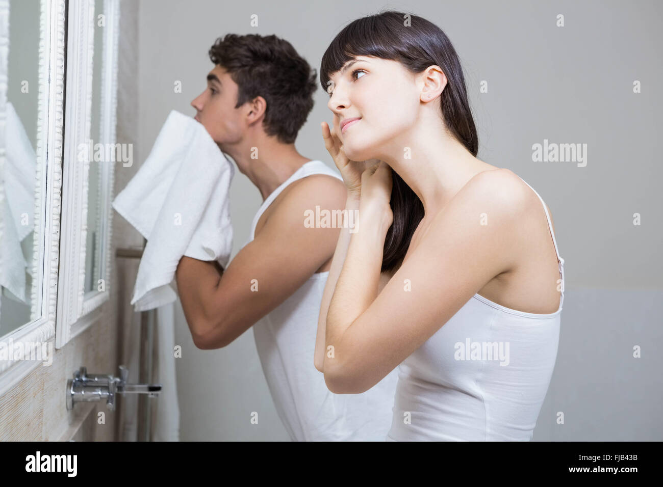 Bathroom routine for young couple Stock Photo