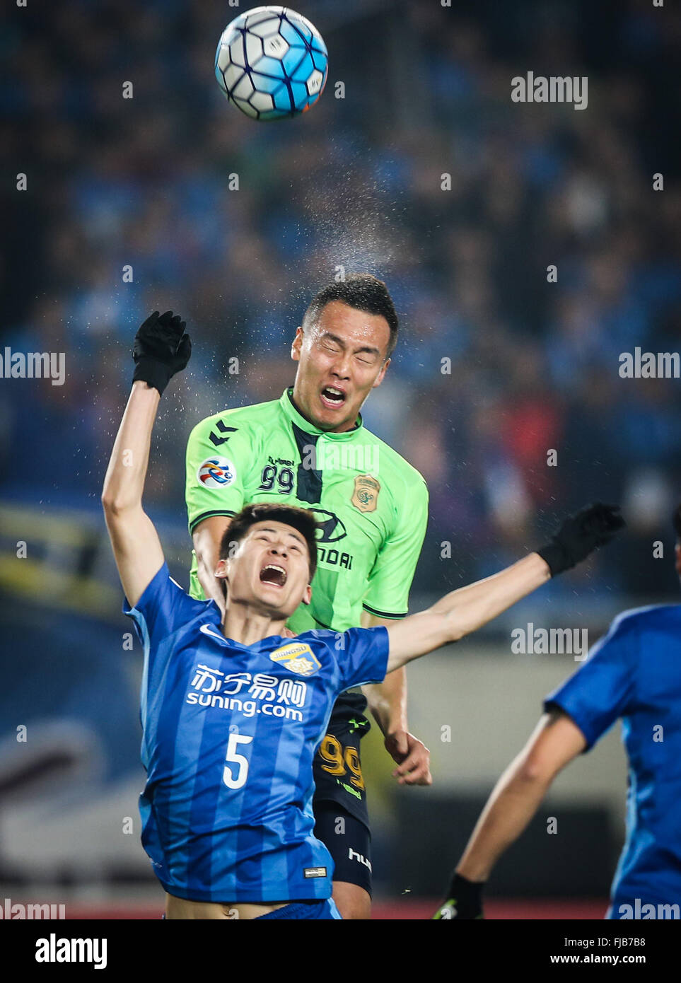 Nanjing, China's Jiangsu Province. 1st Mar, 2016. Zhou Yun (below) of China's Jiangsu FC vies with Kim Shin Wook of South Korea's Jeonbuk Hyundai Motors during the group E match of the AFC Champions League 2016 against South Korea's Jeonbuk Hyundai Motors in Nanjing, capital of east China's Jiangsu Province, on March 1, 2016. Credit:  Yang Lei/Xinhua/Alamy Live News Stock Photo