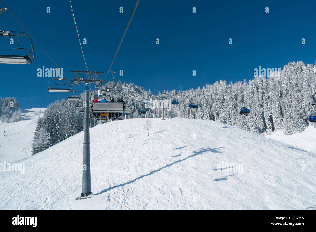 On a ride on a chairlift in the Brauneck ski resort in Lenggries, Bavaria, Germany Stock Photo