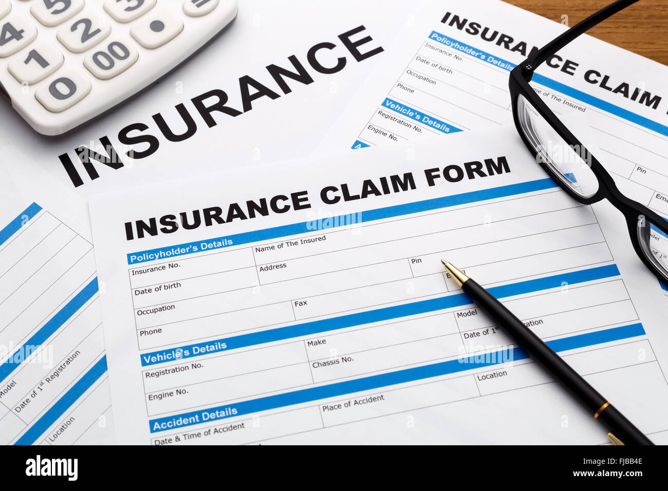 Insurance claim form with pen and calculator Stock Photo