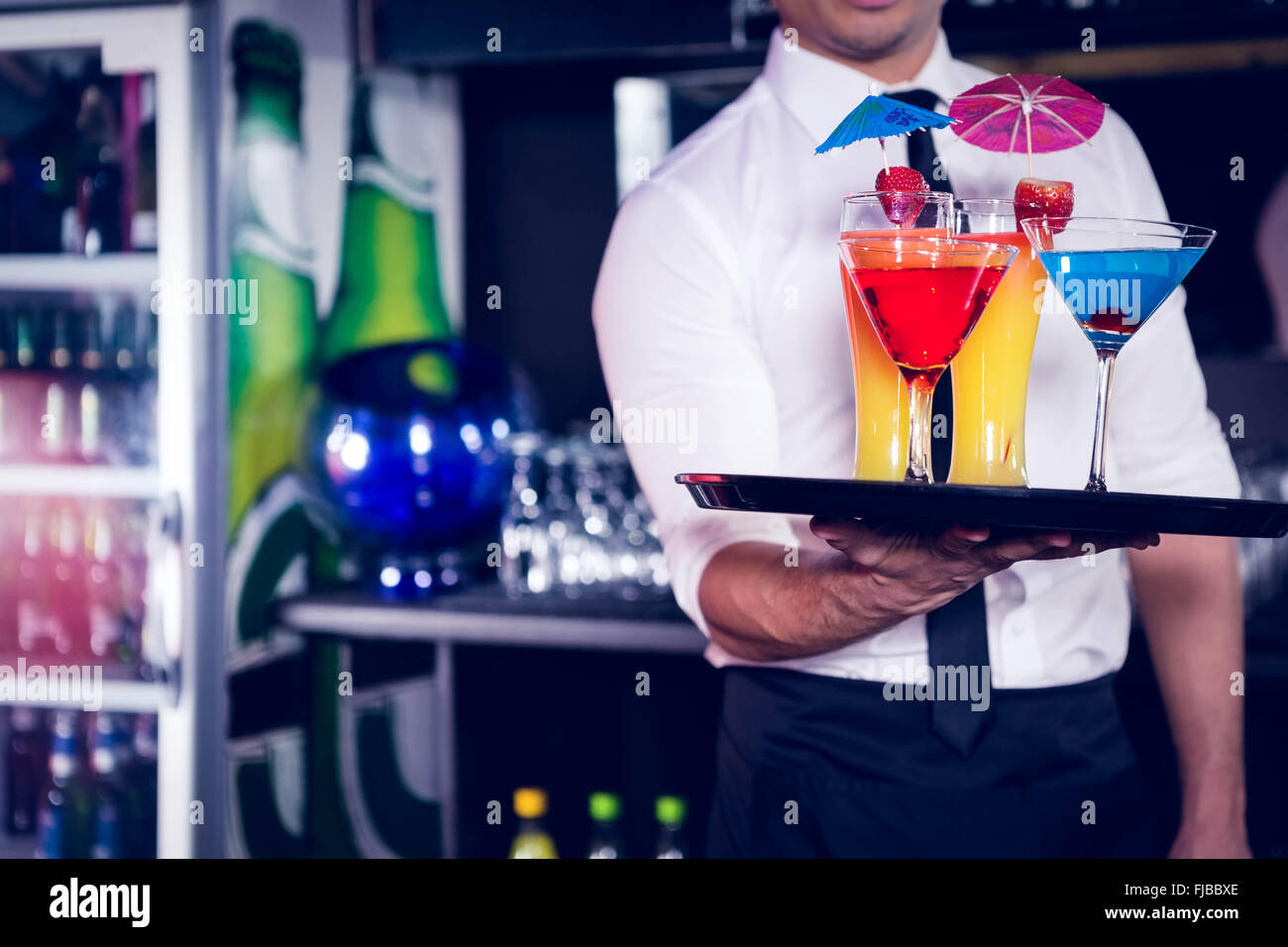 Mid section of bartender serving cocktail and martini Stock Photo