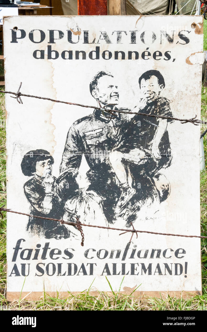 World war two German propaganda sign. In French, showing German soldier looking after two abandoned French children Stock Photo