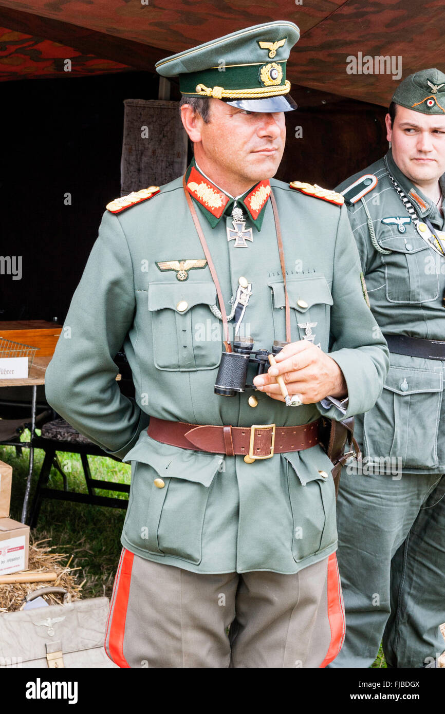 War and peace show. England. WW2 re-enactment. Handsome German General standing facing, no eye contact. Holding binoculars, one hand behind back. Stock Photo
