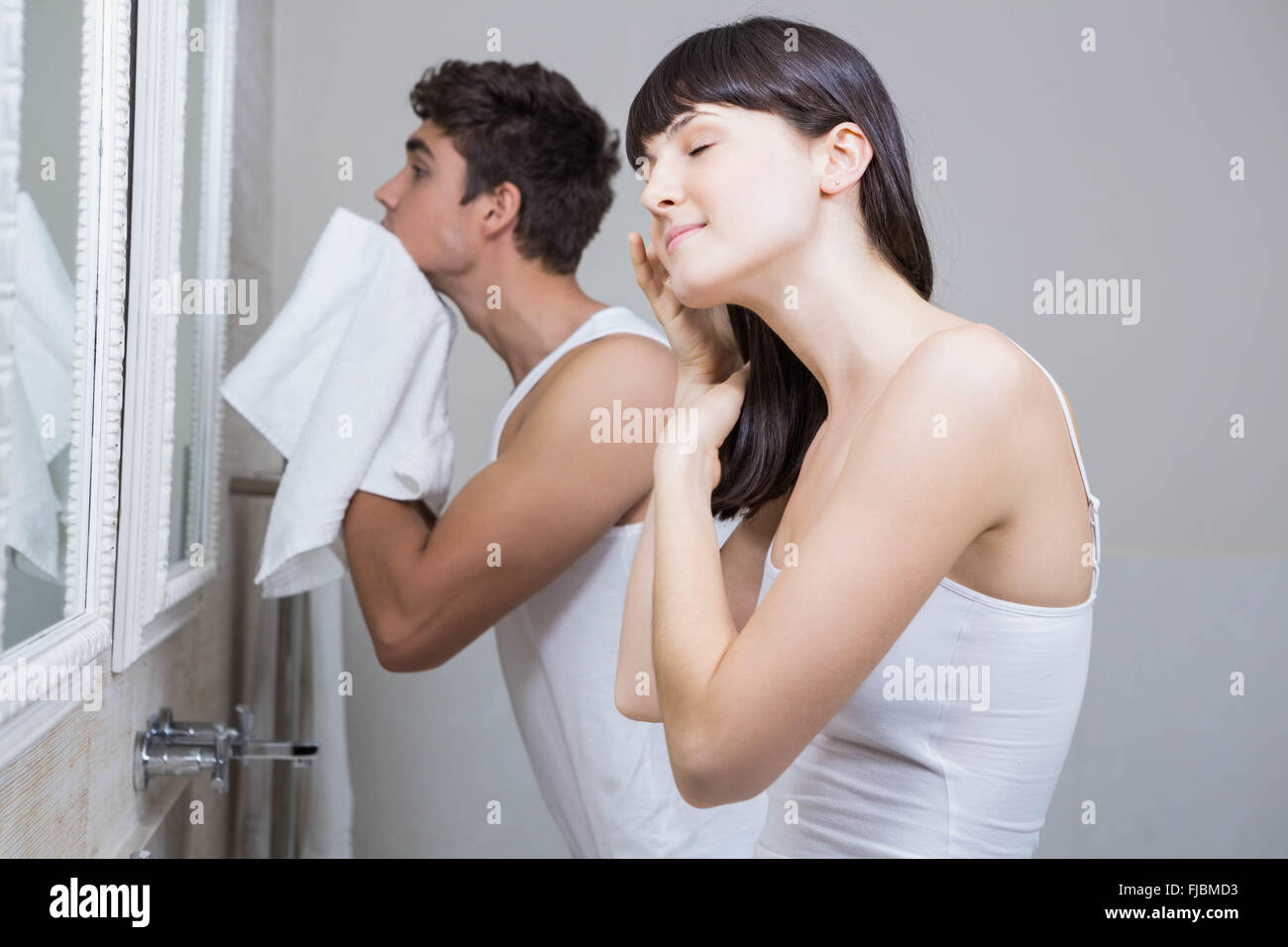 Bathroom routine for young couple Stock Photo