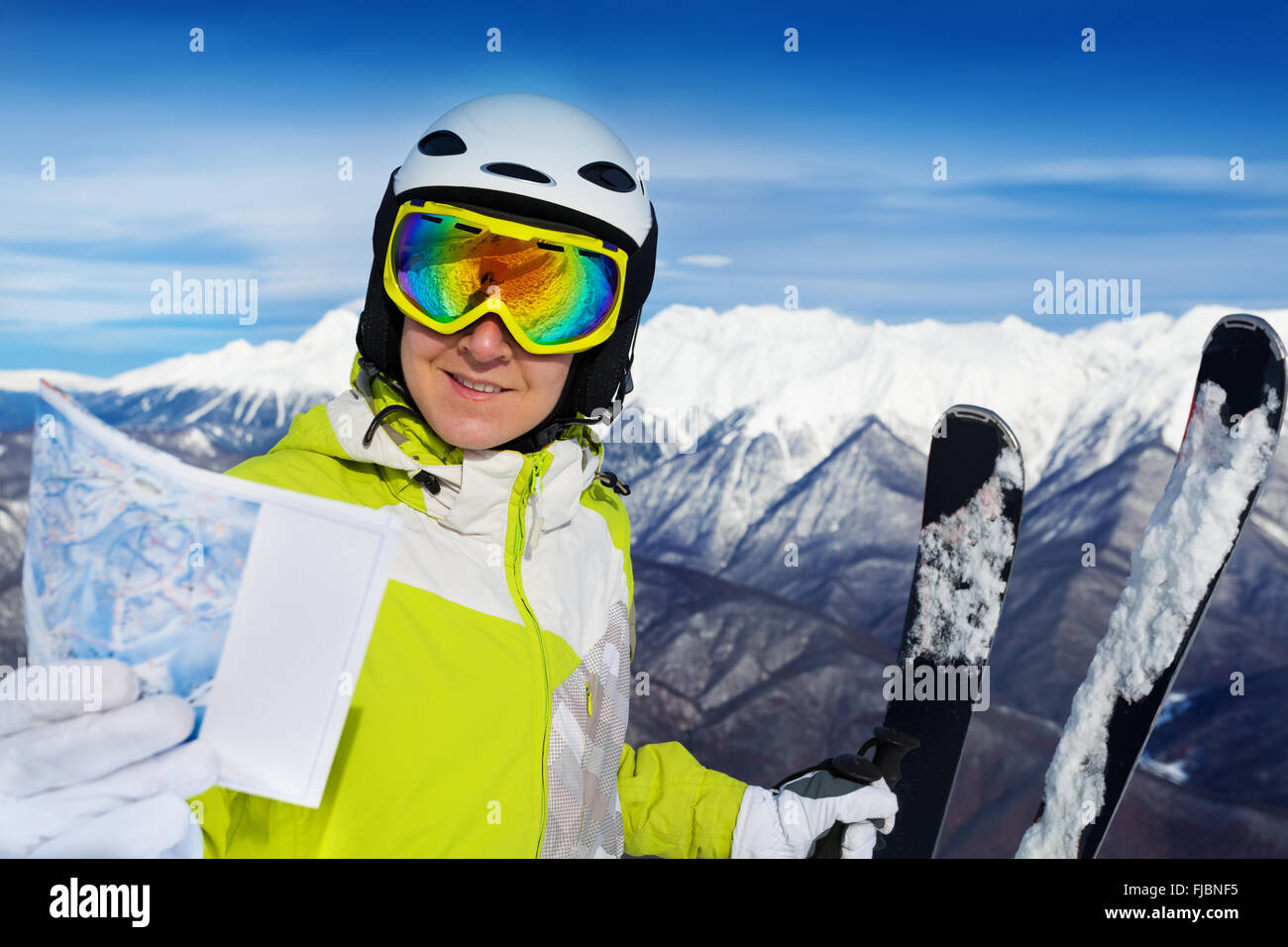 Woman with ski track map on the mountain Stock Photo