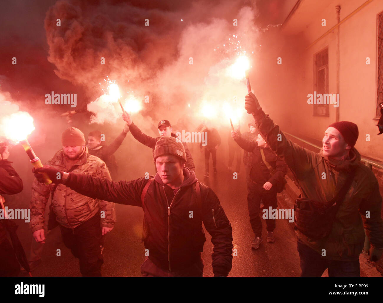 January 21, 2016 - Members and supporters of regiment ''Azov'' light flares during a protest against detention of Head of the Civil Corps ''Azov-Crimea'' Stanislav Krasnov and activist Oksana Shelest in Kiev, Ukraine on March 01, 2016. Stanislav Krasnov and activist Oksana Shelest was detained by the Security Service of Ukraine on the night of 28 February, and preliminarily charged with illegal possession of weapons and connections with the Russian intelligence agencies, according to local media. © Anatolii Stepanov/ZUMA Wire/Alamy Live News Stock Photo