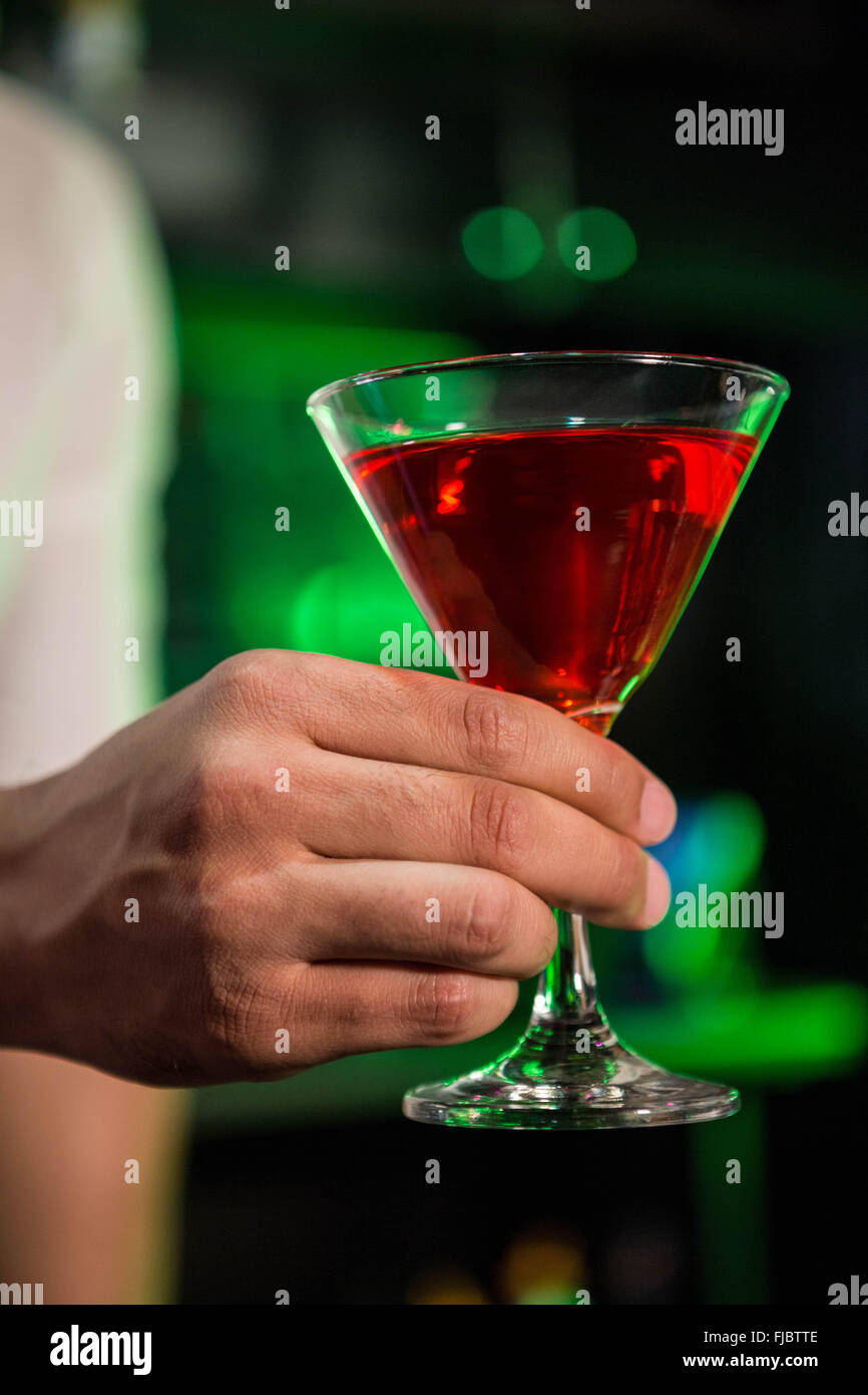 Bartender serving a red martini Stock Photo