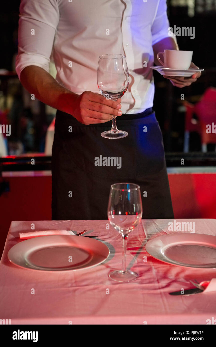 Waiter setting a table Stock Photo