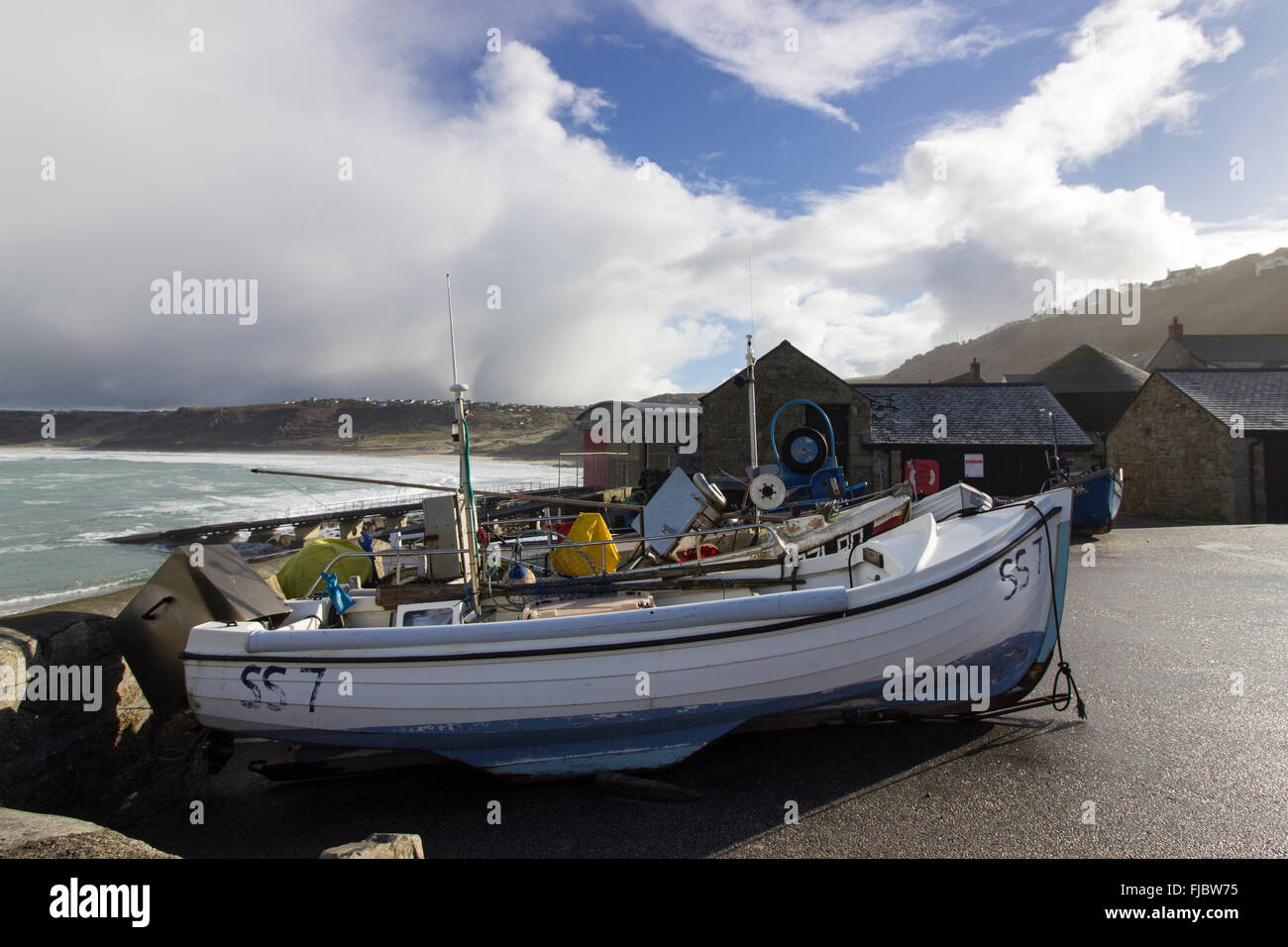 Onshore fishing boats hauled up by the harbour at Sennen Cove, Cornwall ...