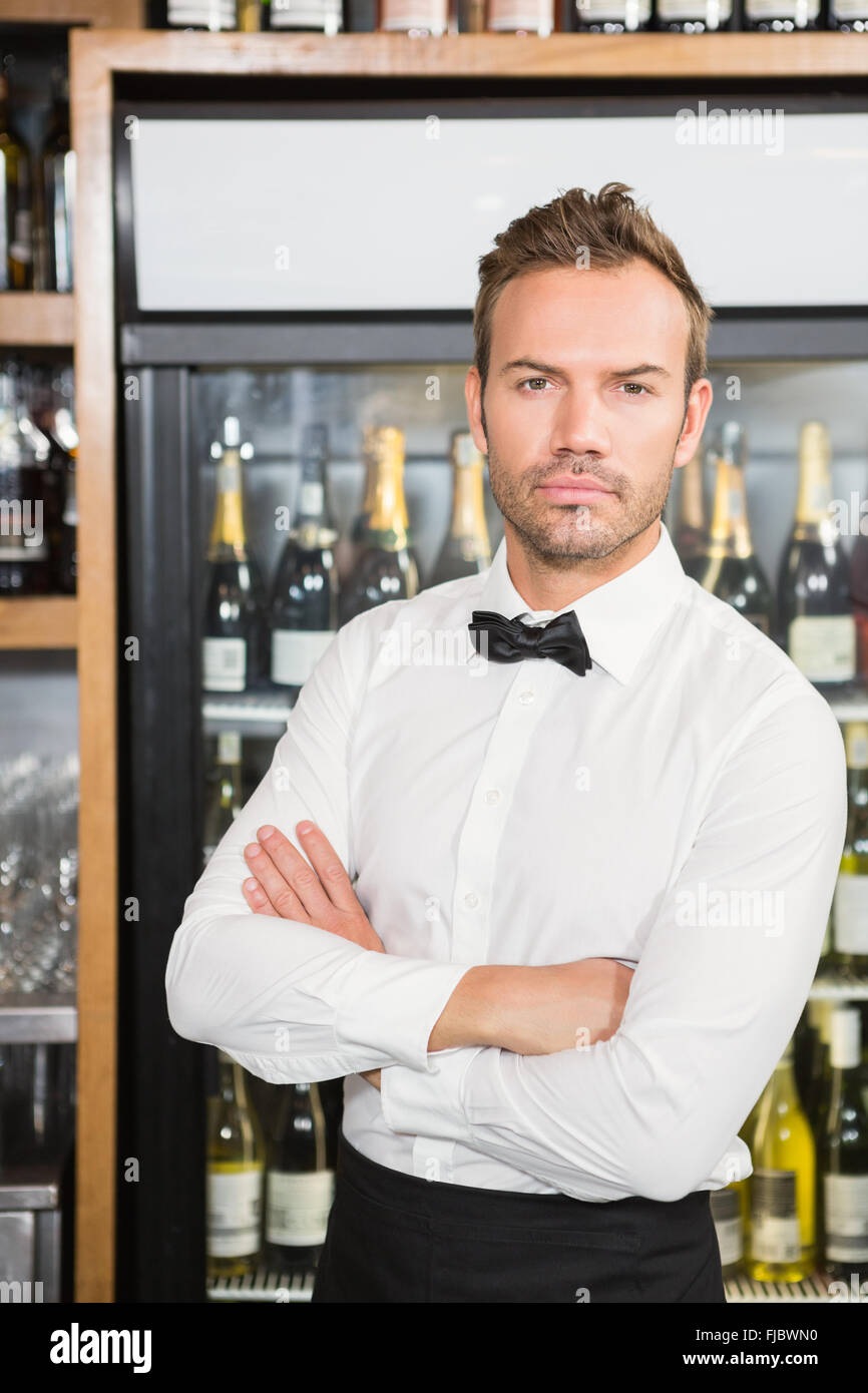 Handsome barman crossing his arms Stock Photo
