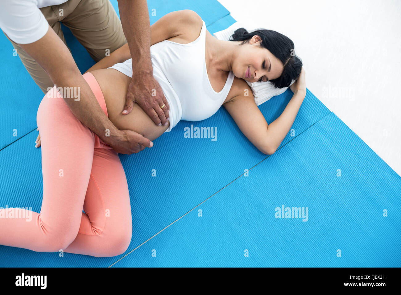 Doctor giving physiotherapy to pregnant woman Stock Photo