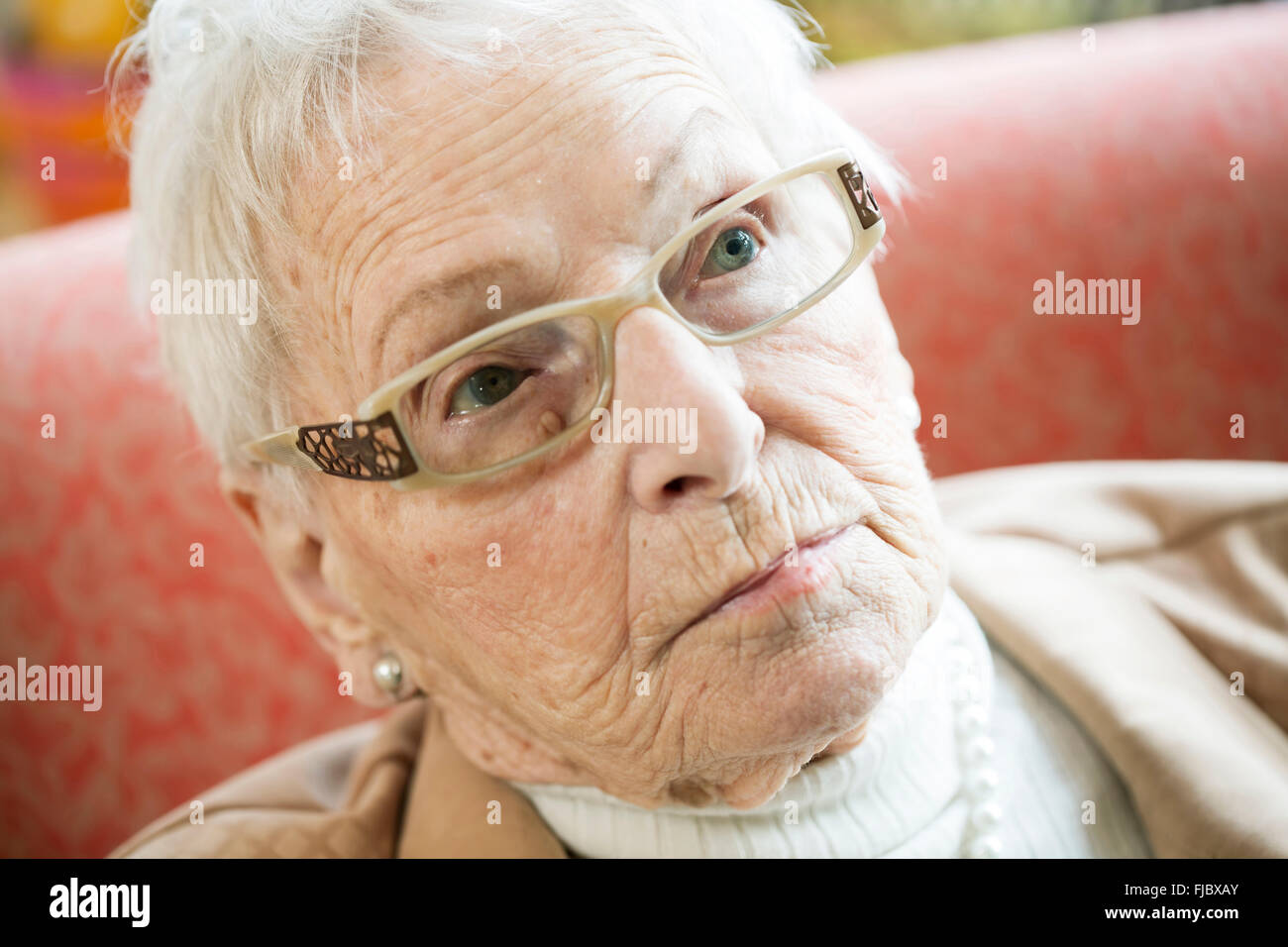 Senior suffering from dementia in a retirement home looking skeptical, portrait, Cologne, North Rhine-Westphalia, Germany Stock Photo
