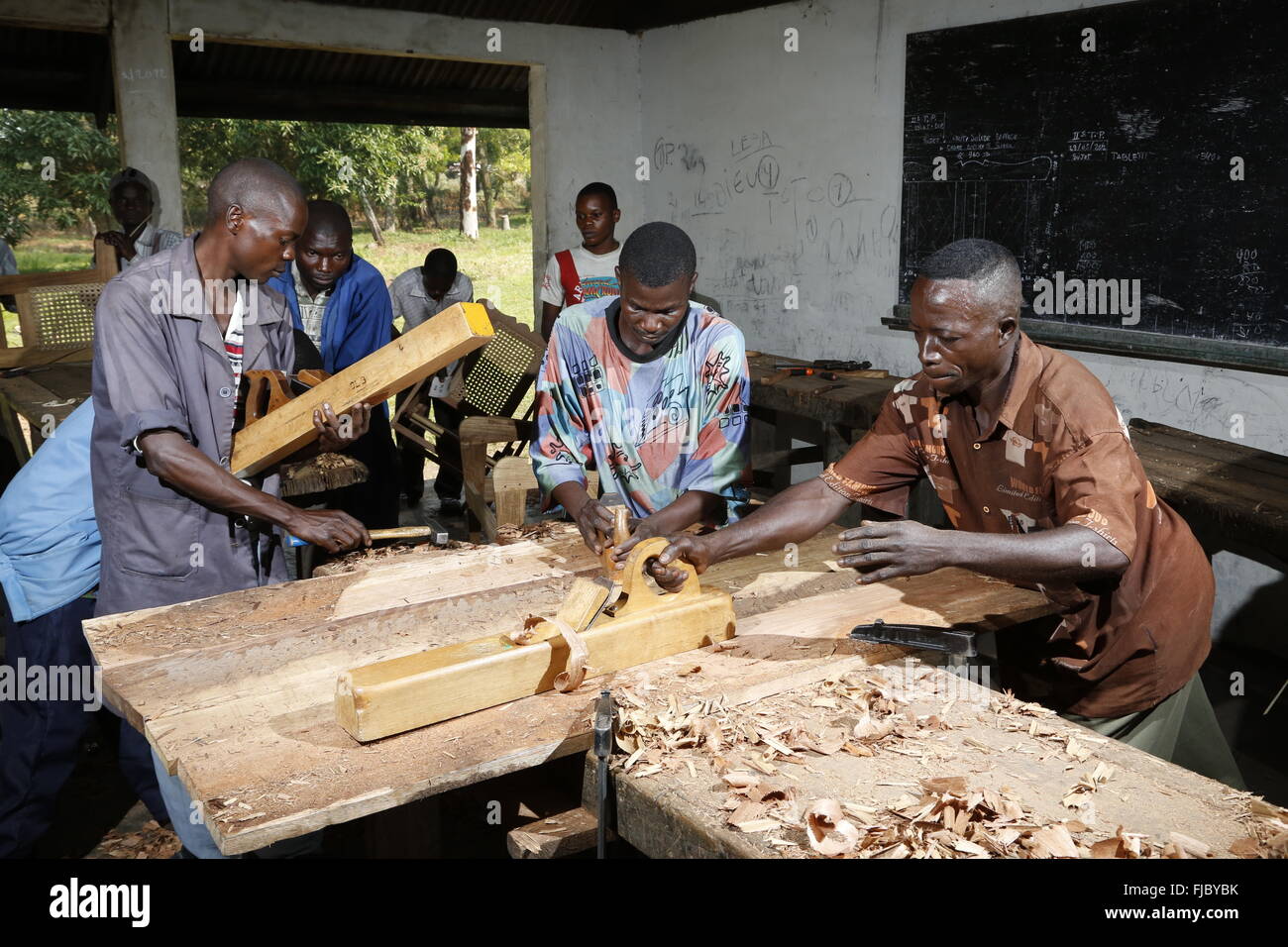Apprentices planing wood, carpentry and joinery workshop, Matamba-Solo, Bandundu Province, Republic of the Congo Stock Photo