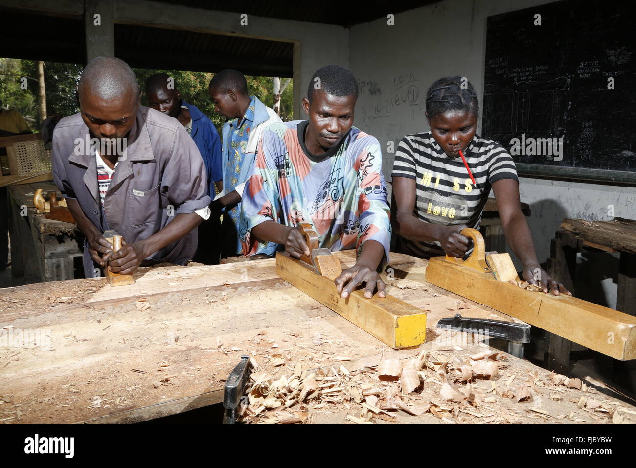 Apprentices planing wood, carpentry and joinery workshop, Matamba-Solo, Bandundu Province, Republic of the Congo Stock Photo