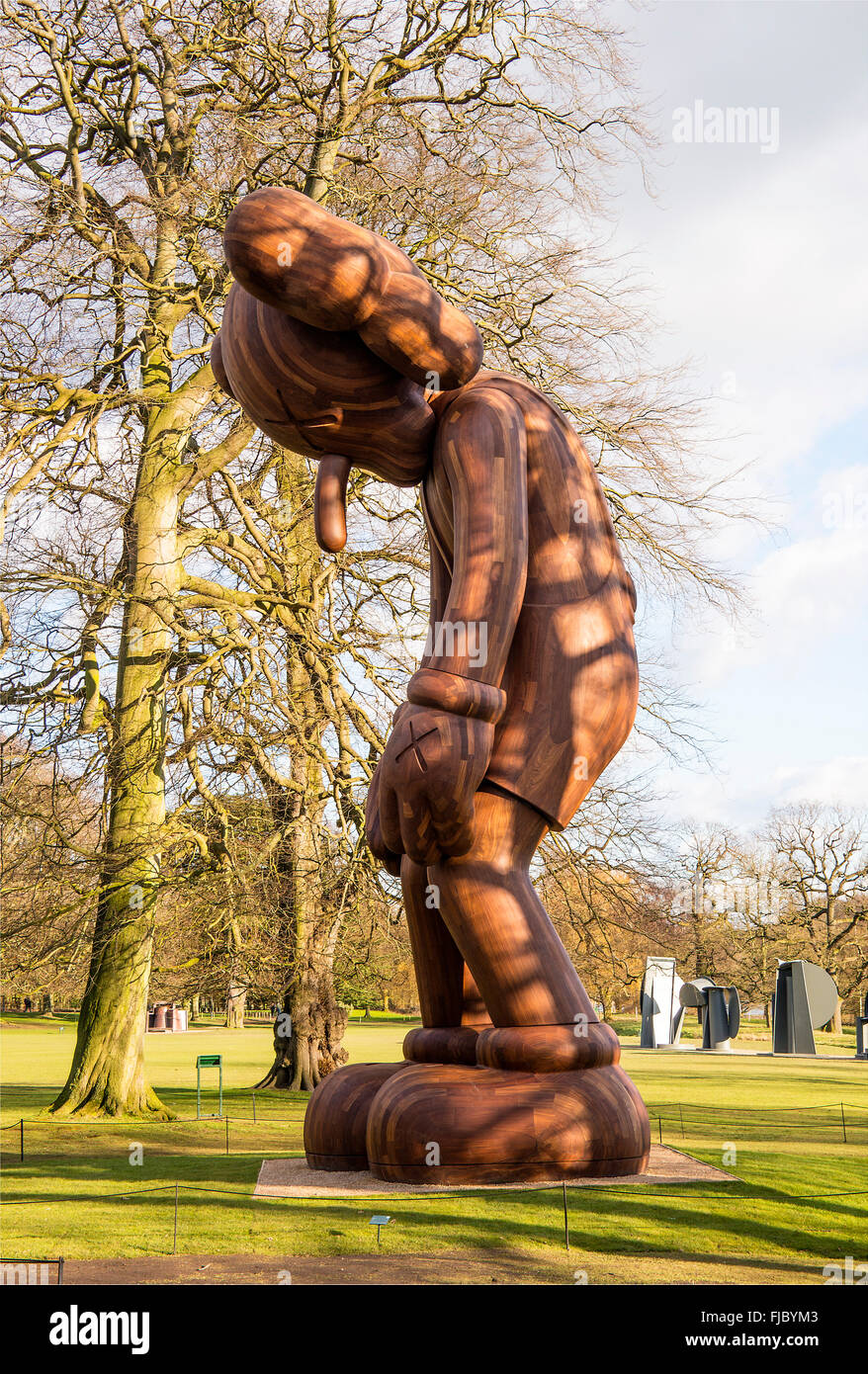 Kaws small lie wooden sculpture hi-res stock photography and