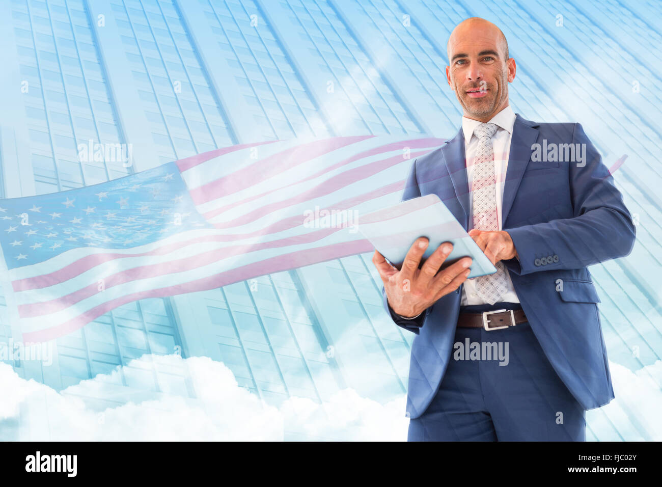 Composite image of businessman using a tablet and smiling at the camera Stock Photo