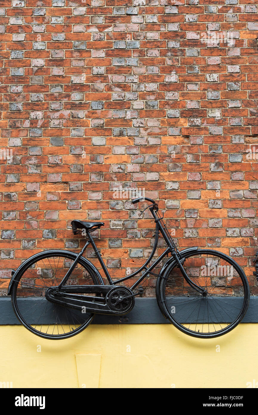 Bicycle hung on a wall outside a bicycle shop. Oxford. England Stock