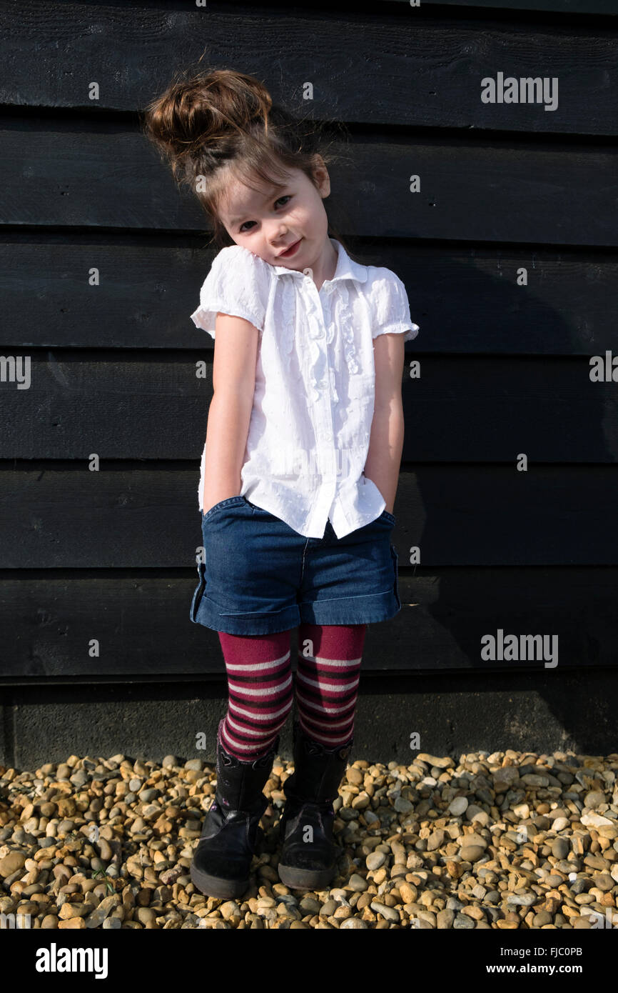 4-Year old girl wearing denim shorts over wool tights Stock Photo