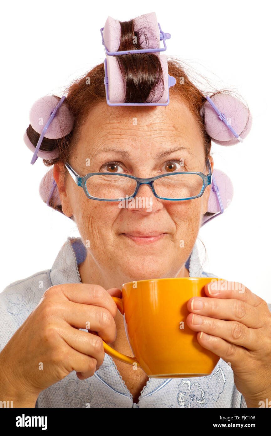 Cheerful Middle-aged Woman With Hair Curlers and Coffee Cup Stock Photo