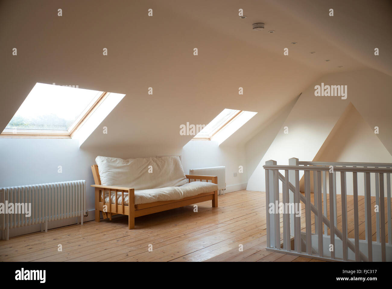 Loft conversion with sofa and windows Stock Photo Alamy