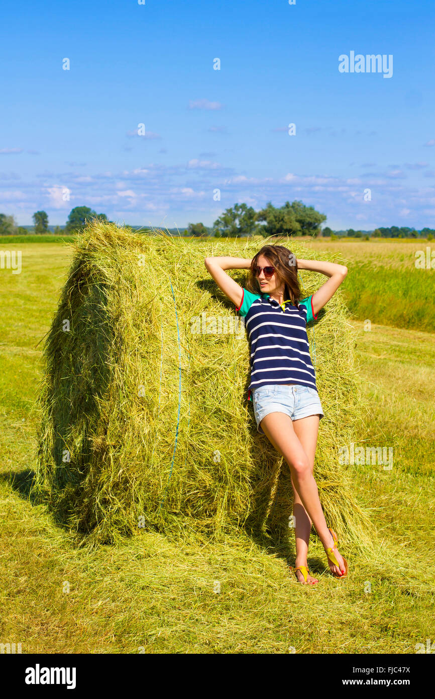 Ð¡oquette girl on the sunny field. Stock Photo