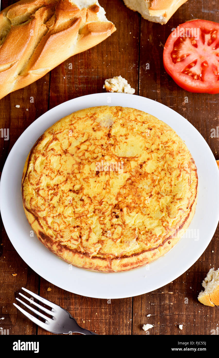 closeup of a plate with a typical tortilla de patatas, a spanish omelet, on a dark wooden table Stock Photo