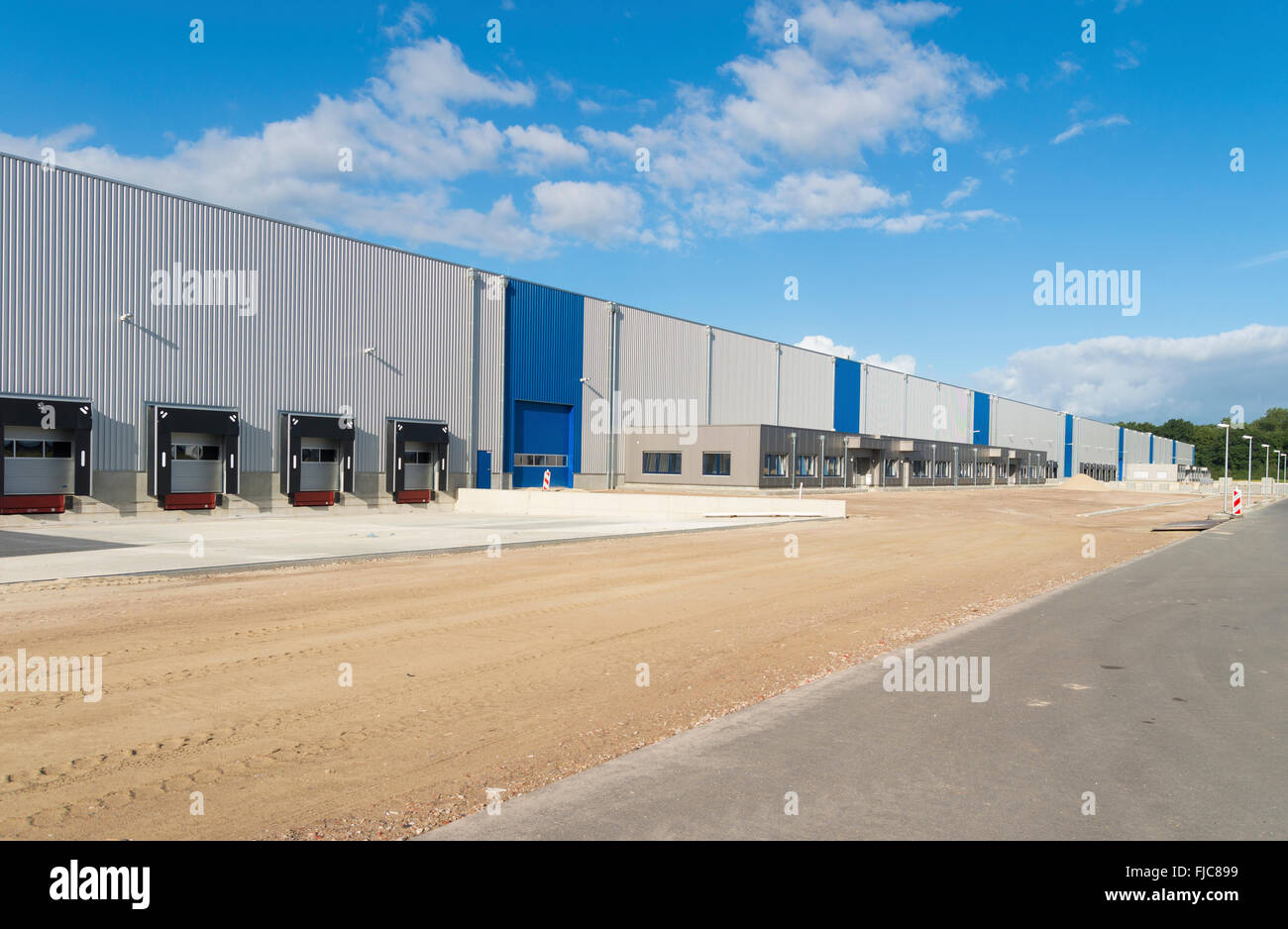 exterior of a newly build warehouse with loading docks Stock Photo