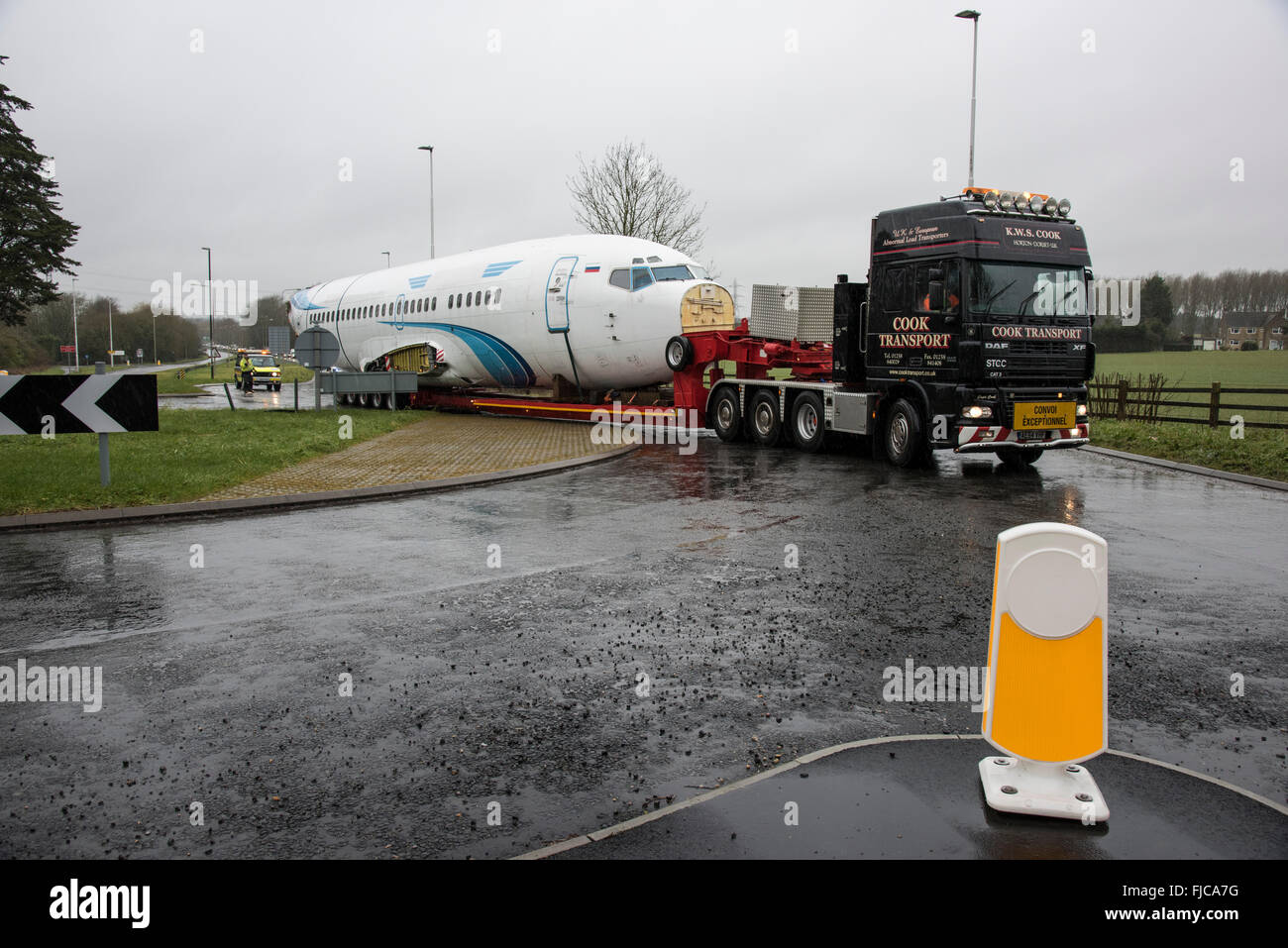 Cook Transport low loader truck taking an abnormal load consisting of a Boeing 737 airliner fuselage along the A419 near Cirence Stock Photo