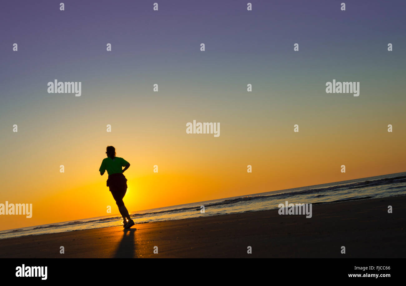 Sunrise Jogger On Beach Stock Photo