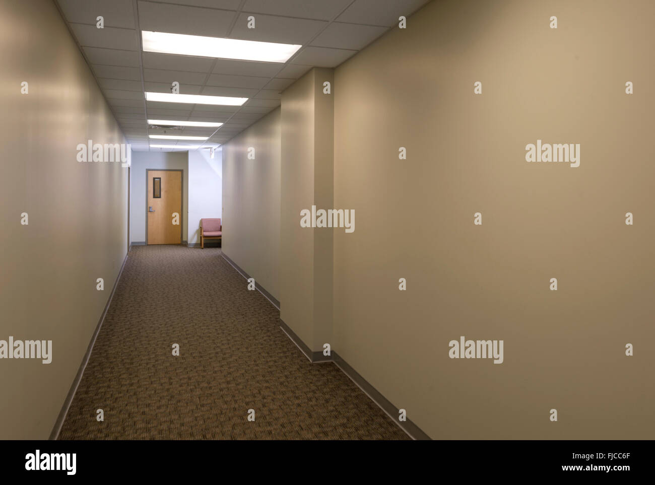 Empty Hallway With Door & Chair At End Stock Photo Alamy
