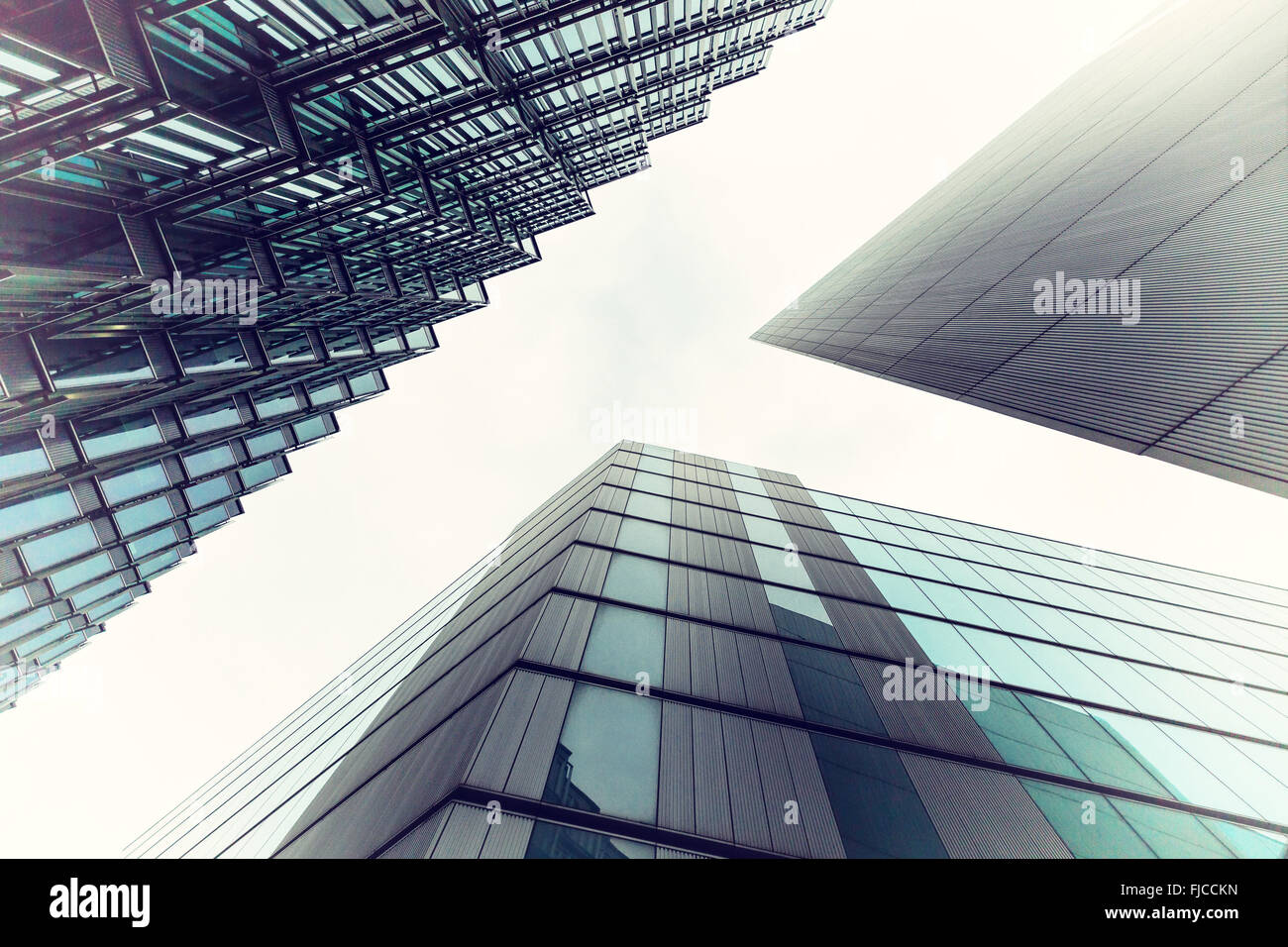 An abstract coloured vintage image, looking up capturing three different buildings on a 45 degree angle with an applied vintage Stock Photo