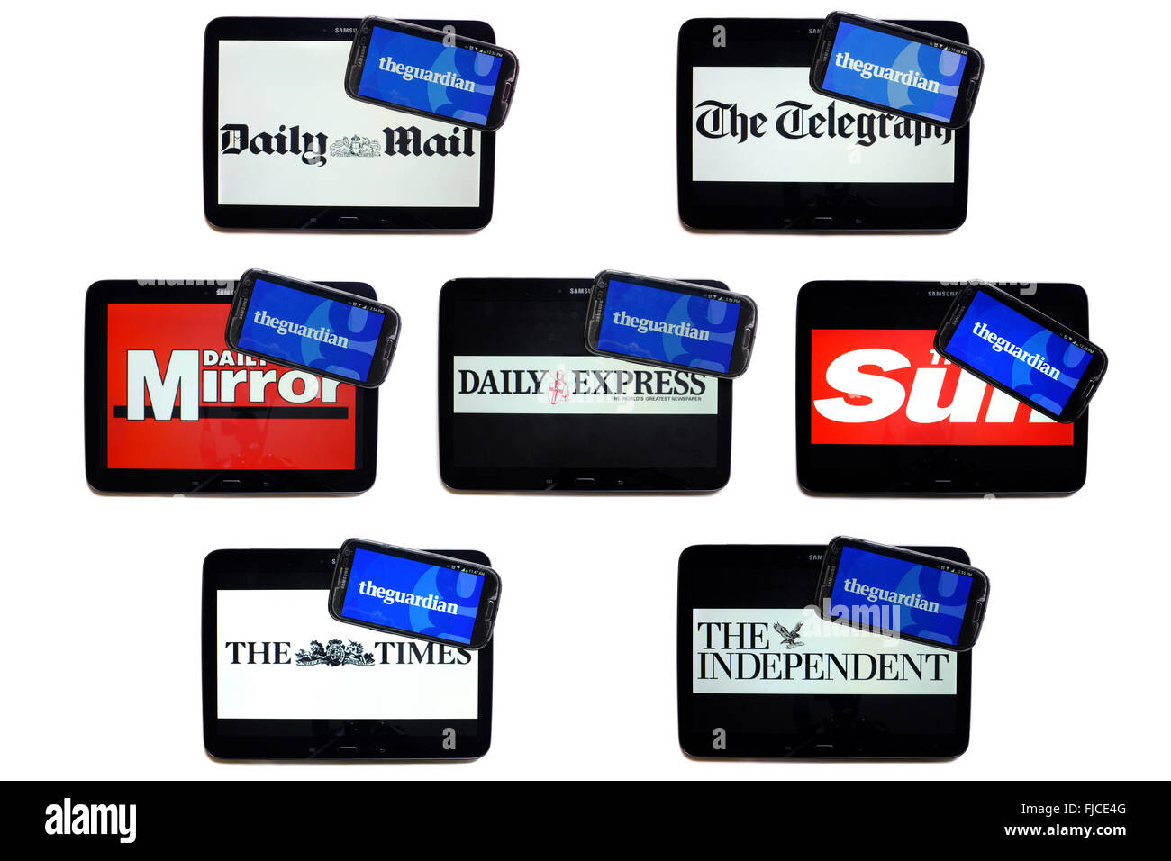The Guardian newspaper logo on smartphone screens surrounded by tablets displaying the logos of rival newspapers. Stock Photo
