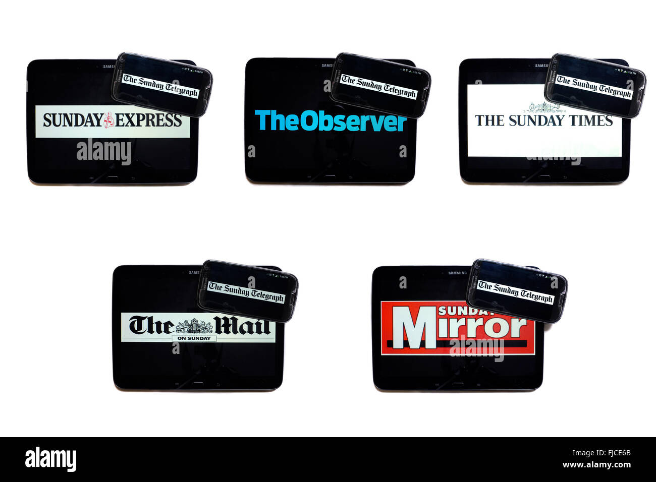 The Sunday Telegraph newspaper logo on smartphone screens surrounded by tablets displaying the logos of rival newspapers. Stock Photo