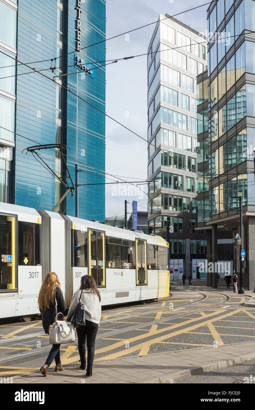 Tram passing Double Tree Hilton hotel, One Piccadilly Place, 1 Auburn Street., Manchester, United Kingdom Stock Photo