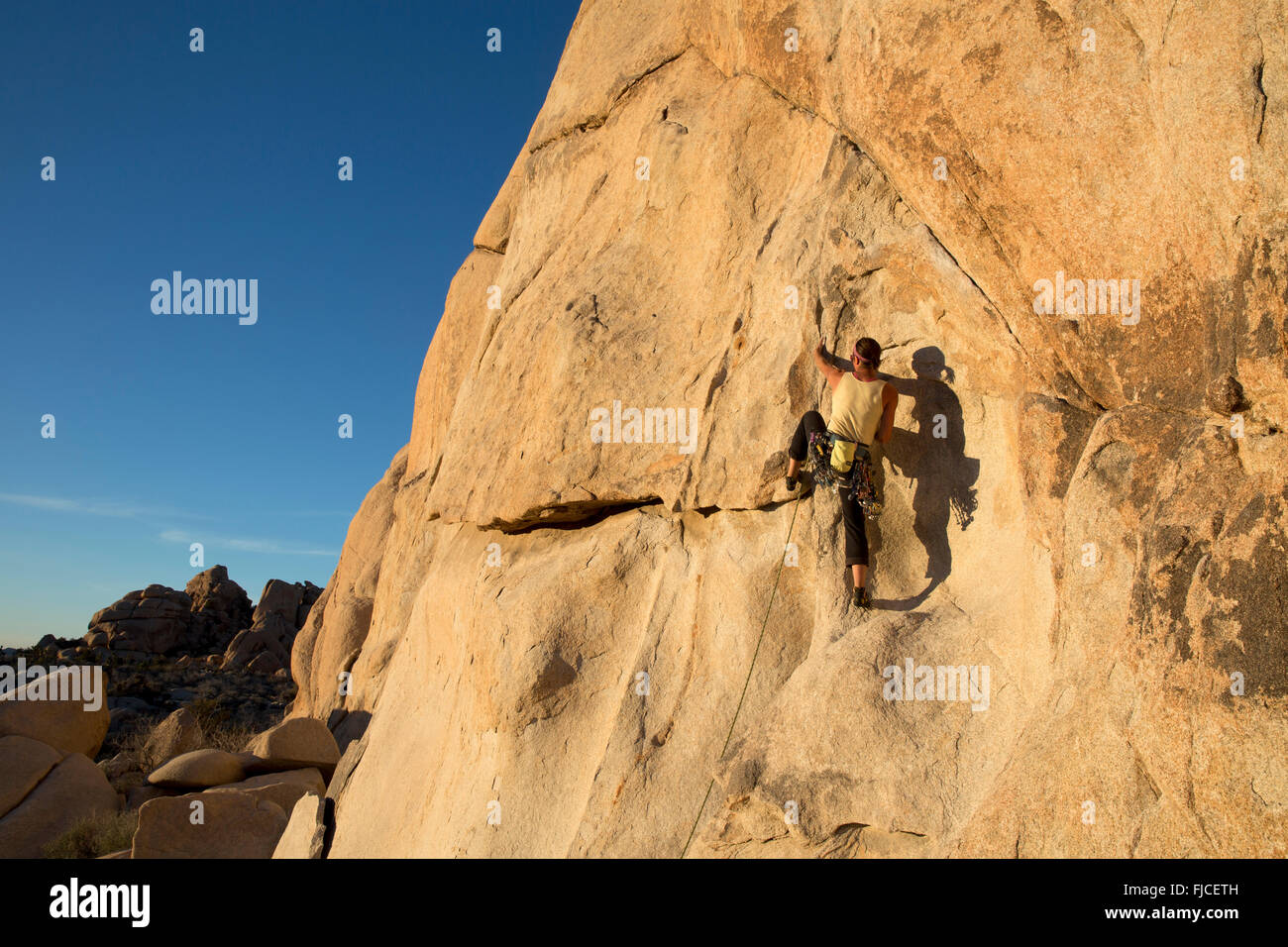 Woman Rock Climbing at Hidden Valley, Joshua Tree National Park California USA Stock Photo