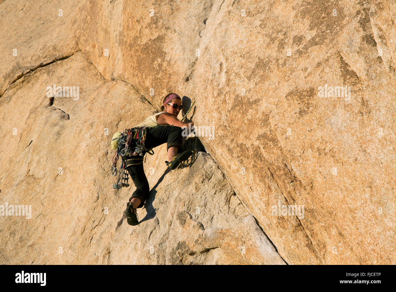 Woman Rock Climbing at Hidden Valley, Joshua Tree National Park California USA Stock Photo