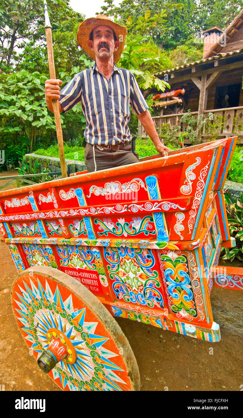 Boyero Cowboy riding his coloful handmade painted Sarchi Ox Cart, La Paz Gardens, Costa Rica Stock Photo