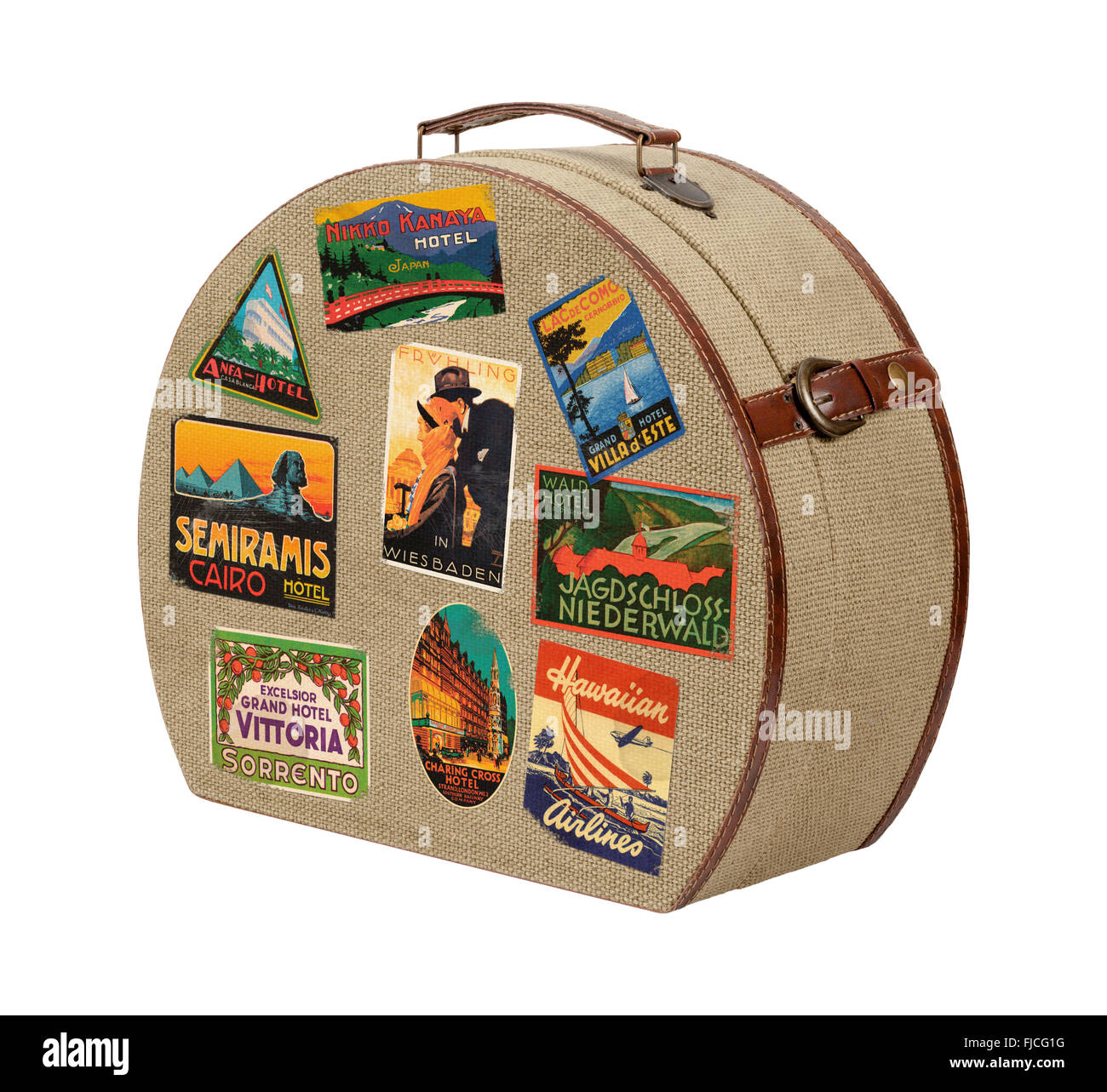 Old Round Burlap Suitcase with Travel Stickers. The image is a cut out, isolated on a white background. Stock Photo