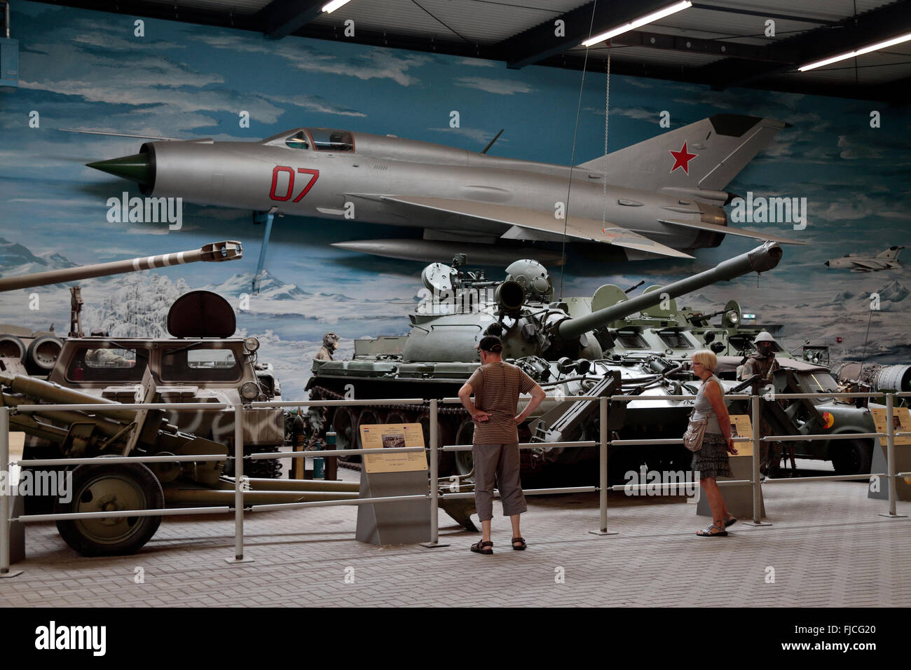 A Soviet Cold War Mig 21 fighter aircraft and other Cold War military vehicles in the Overloon War Museum, Netherlands. Stock Photo